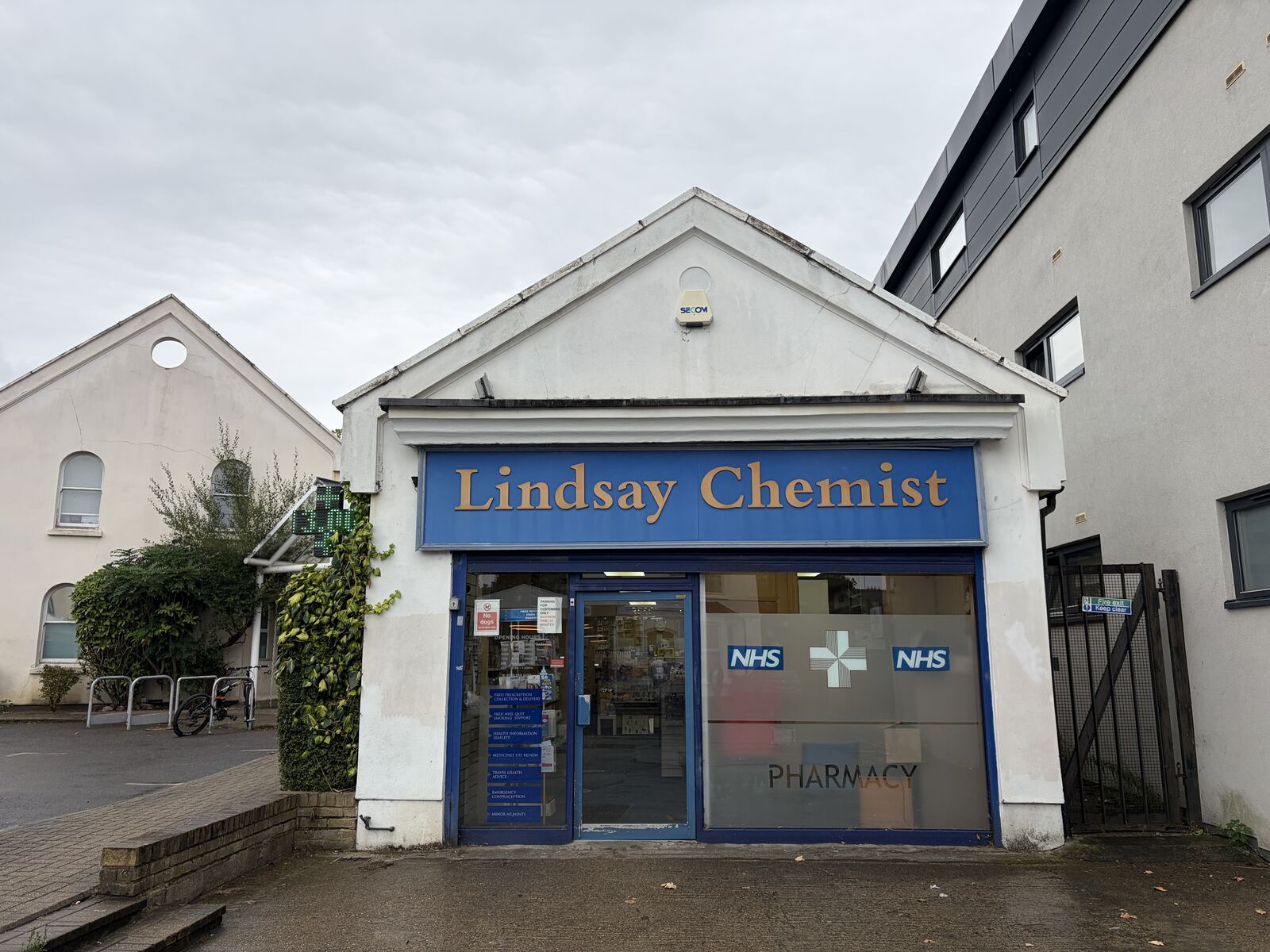 Lindsay Chemist shopfront, a blue-fronted pharmacy with NHS signage